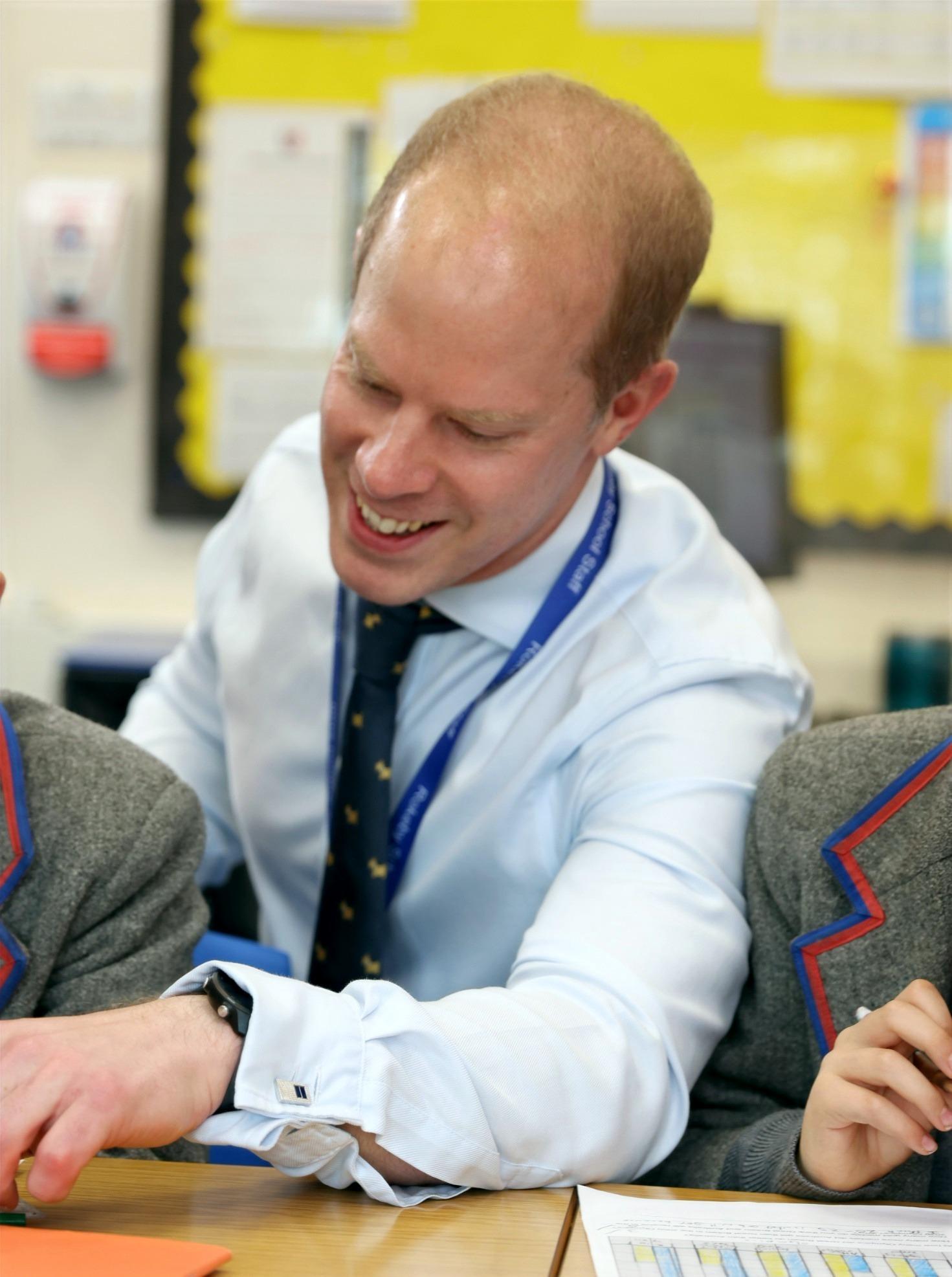Nick Moore tutoring pupils in the classroom